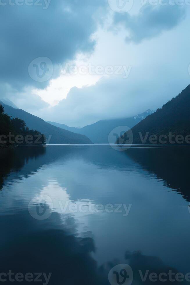 Calm Mountain Lake under Cloudy Sky photo