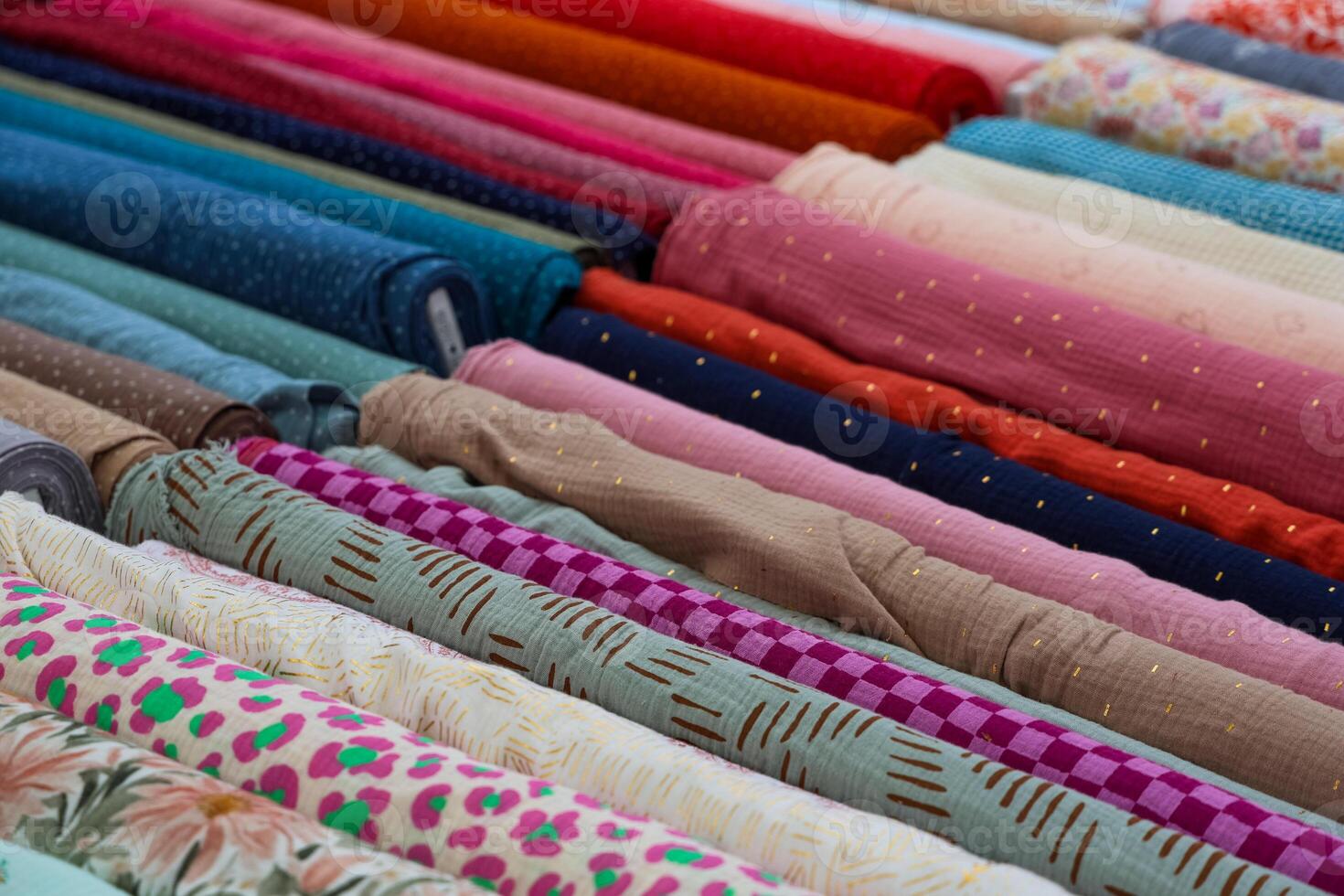 Colorful Fabrics Rolled Up, Displaying Various Patterns and Textures for Sewing and Fashion Design photo