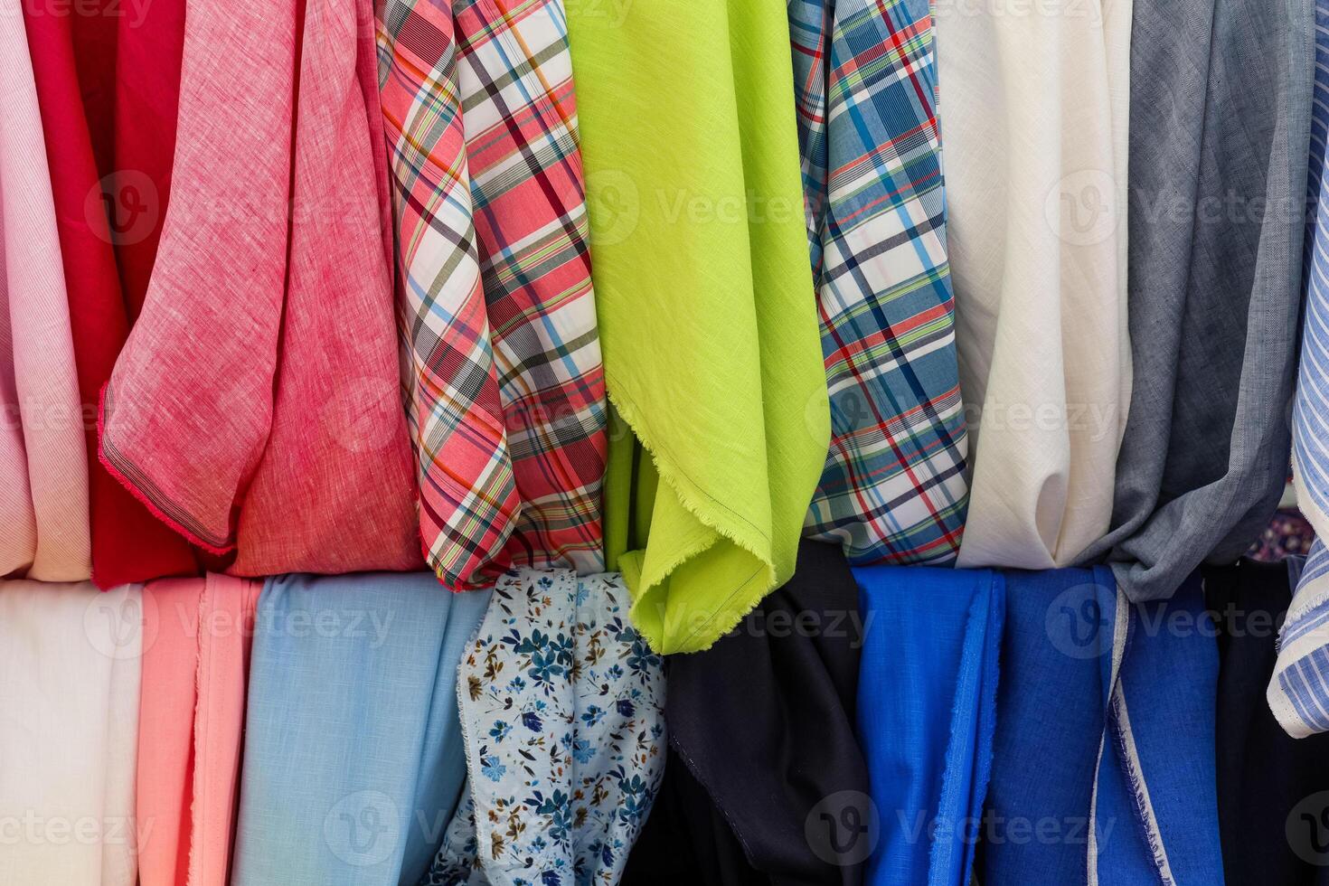 Colorful fabrics hanging in a store, showcasing a variety of textures and patterns photo