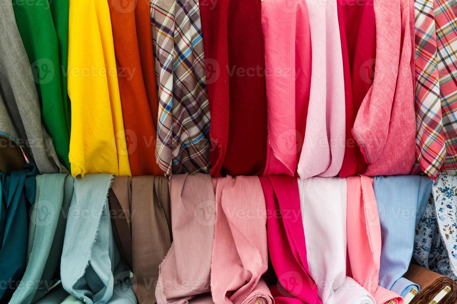 Colorful fabrics hanging in a store, textile industry and retail concept photo