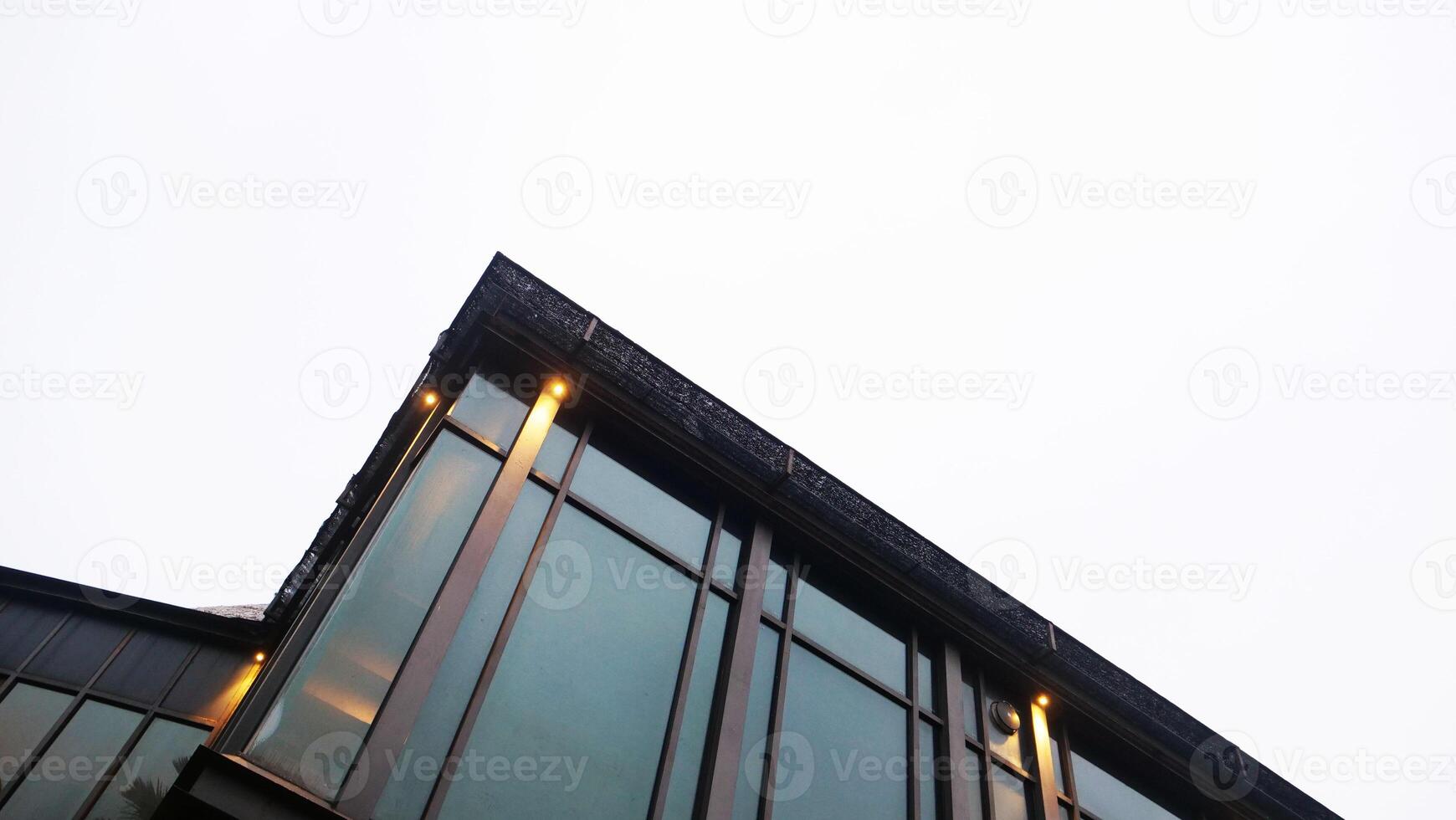 Modern Glass Building Facade with Minimalist Perspective and Soft Lighting photo