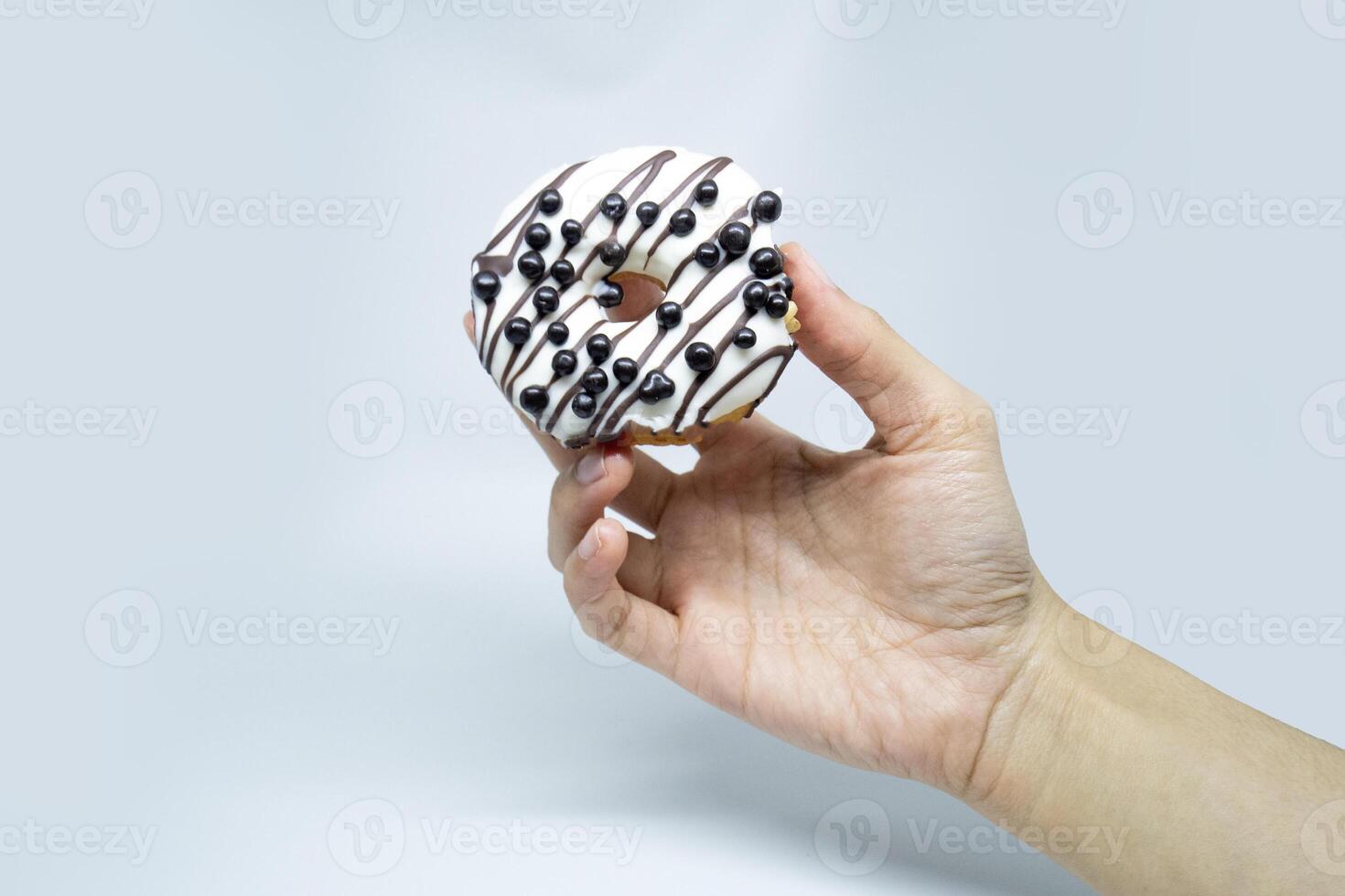 vanilla donuts with choco chips on hold photo