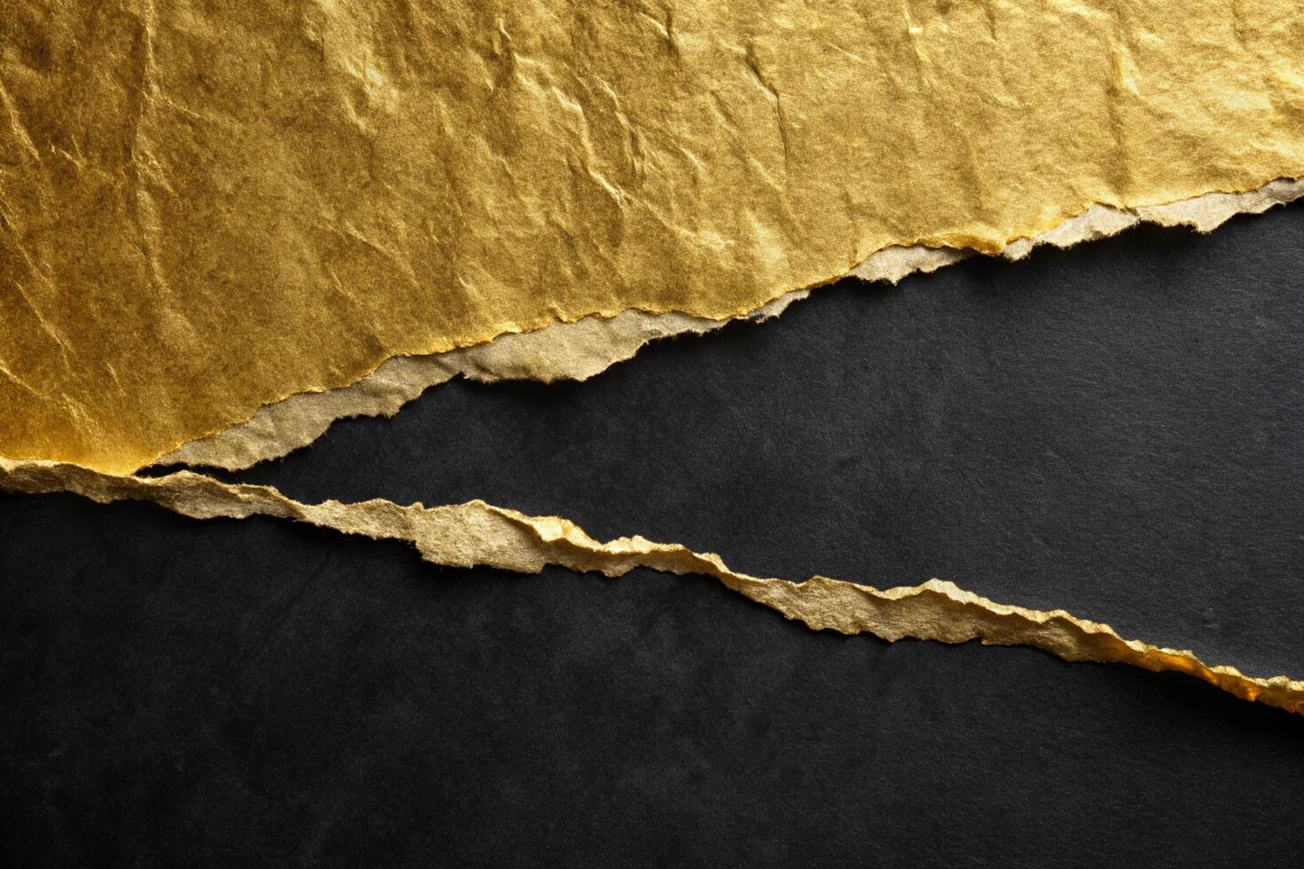 Torn gold paper over a black surface for business presentations and design projects photo