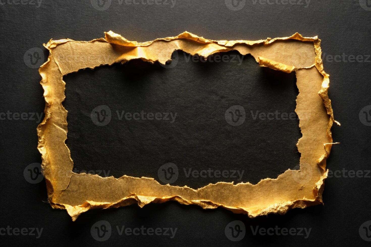 Golden torn paper frame on a black surface for business branding and presentations photo