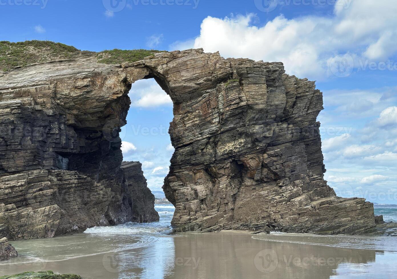 Spectacular natural rock arch formation on the beach of Playa de las Catedrales in Galicia, Spain. photo