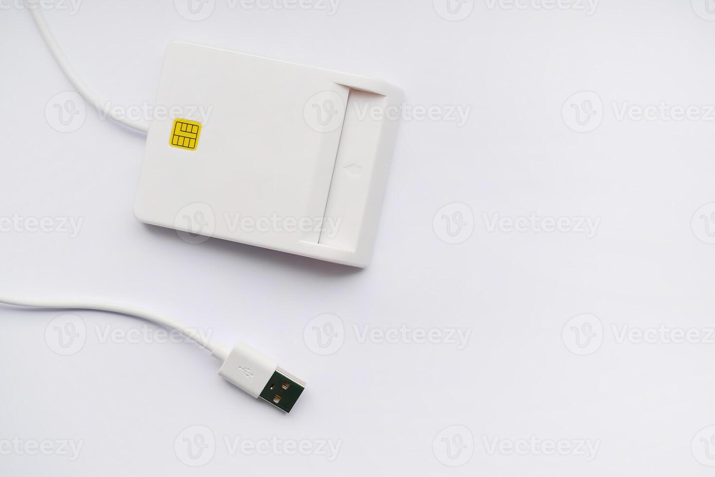 Close-up of a smart card reader with USB cable on a white background photo