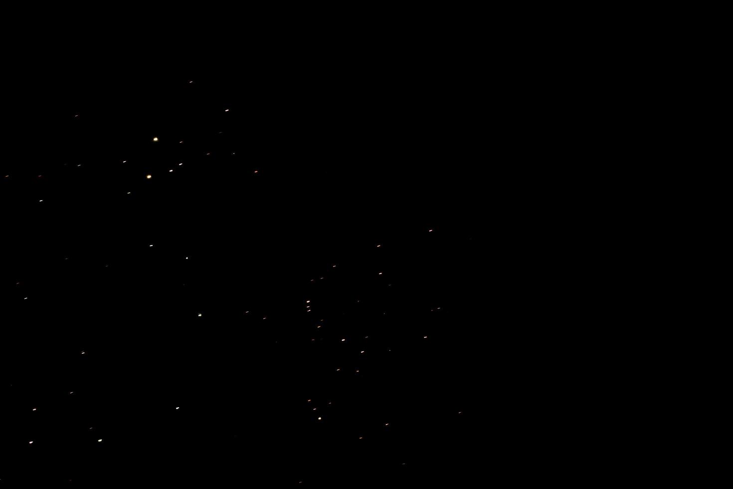 Small golden light particles scattered on dark background, dreamy night sky with sparkling stars fantasy mood photo