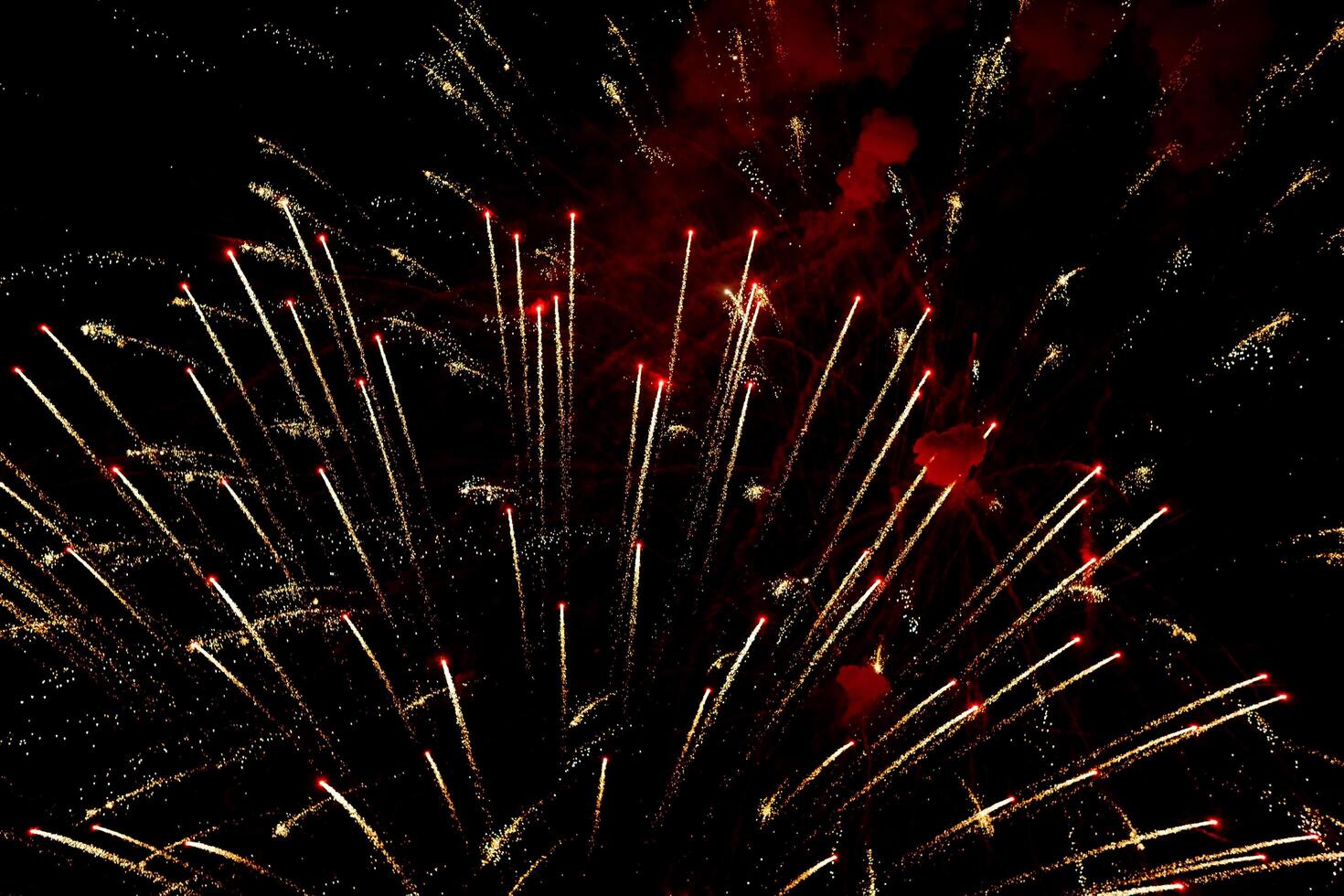 Spectacular fireworks show in night sky, shining sparks and trails perfect for celebration and backgrounds photo