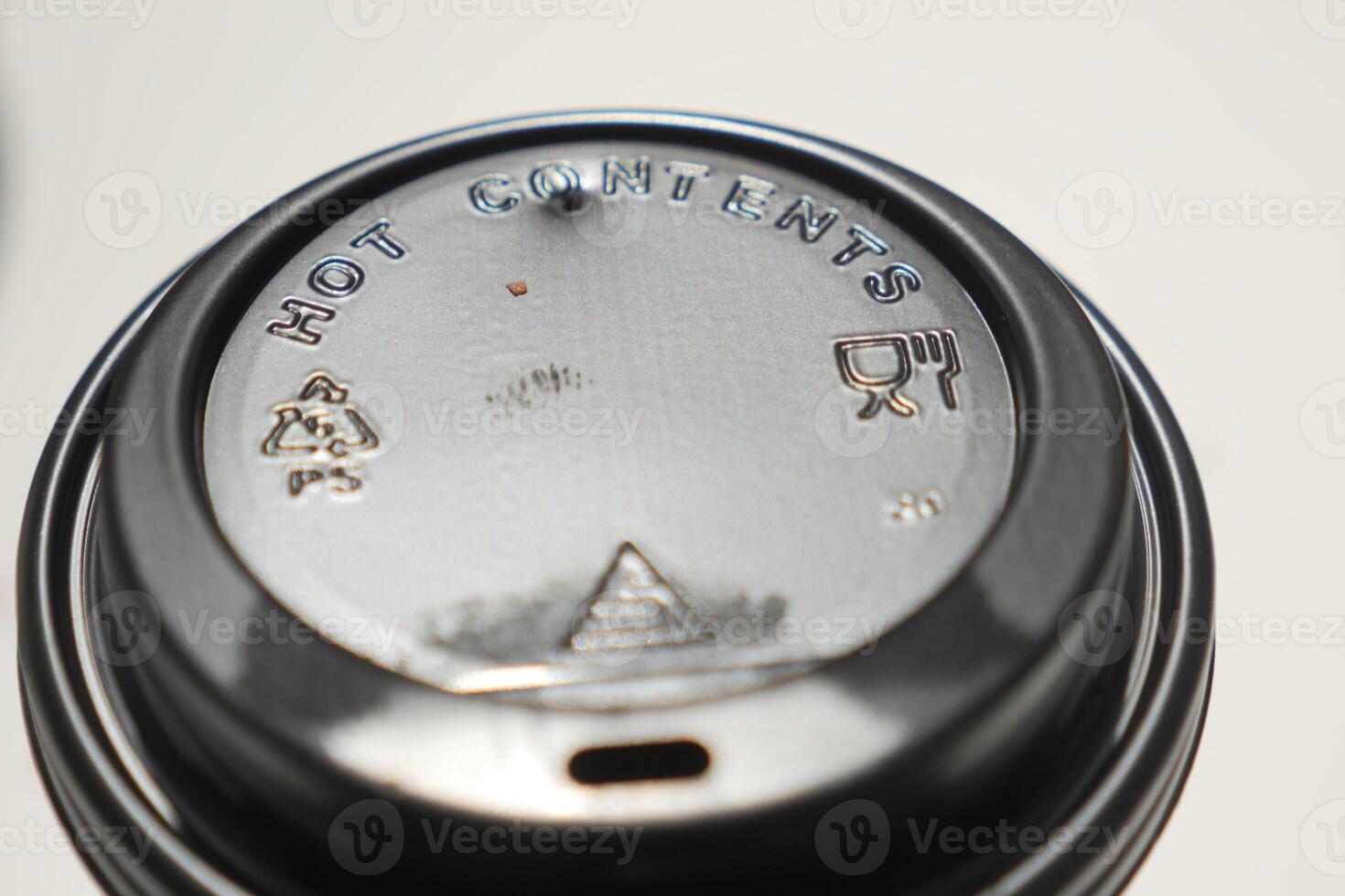 Lid of a hot beverage cup with warning symbols displayed clearly photo