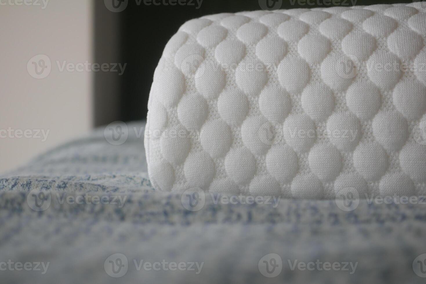 A soft white orthopedic pillow is placed on bed . photo