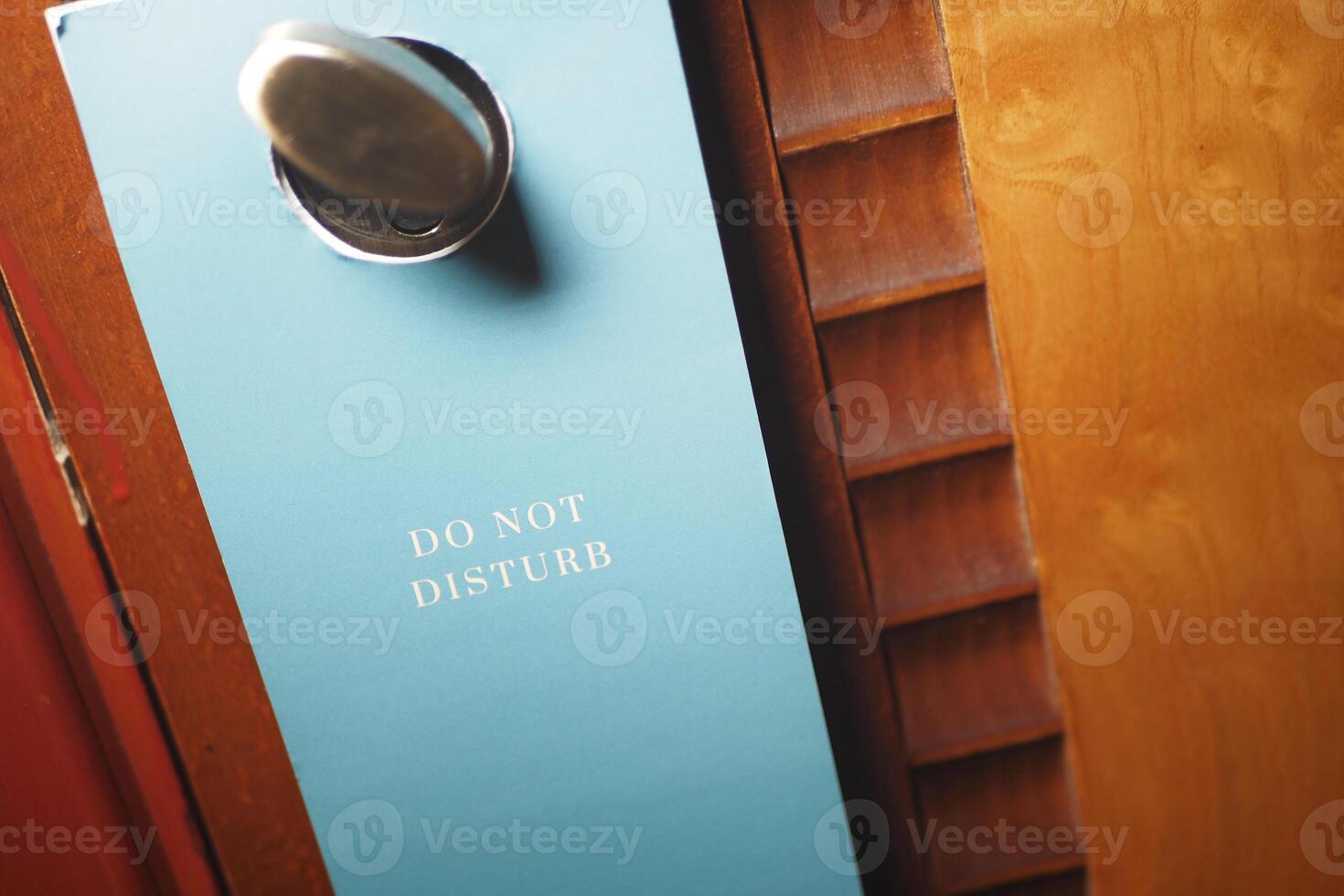 Do not disturb sign hanging on a hotel door photo