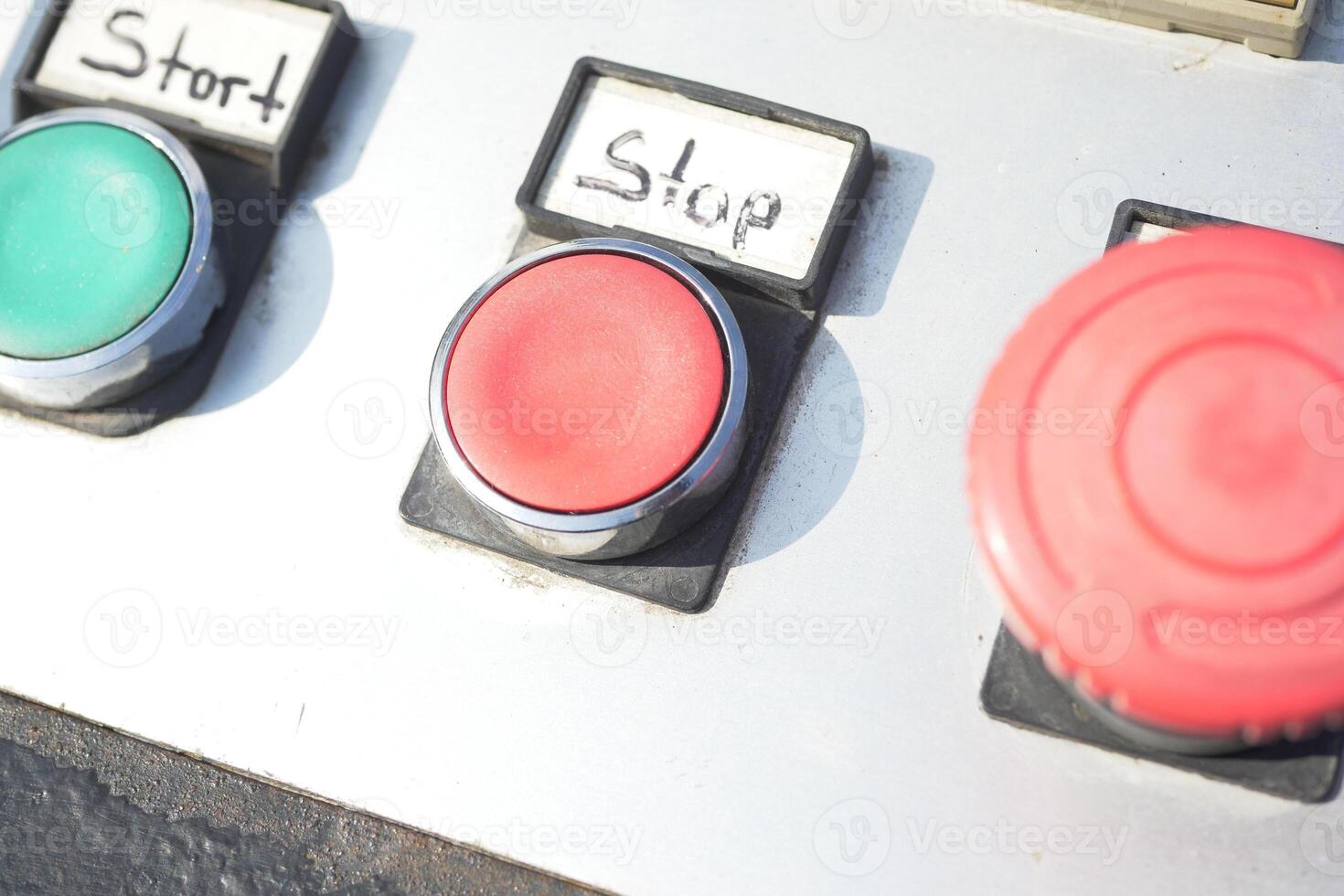Control panel with start and stop buttons in industrial setting photo