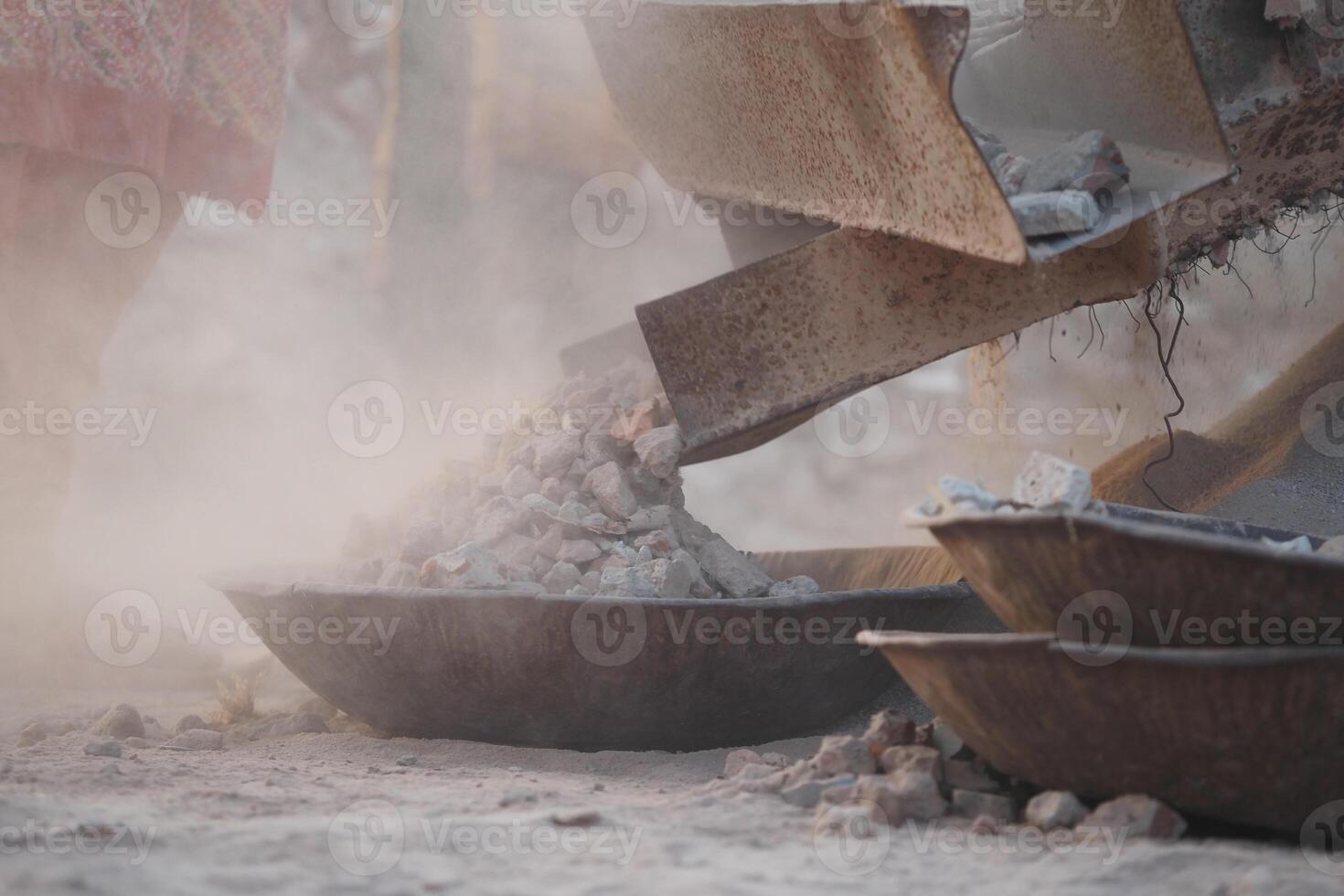 Dusty gravel extraction process in a quarry during daylight hours photo