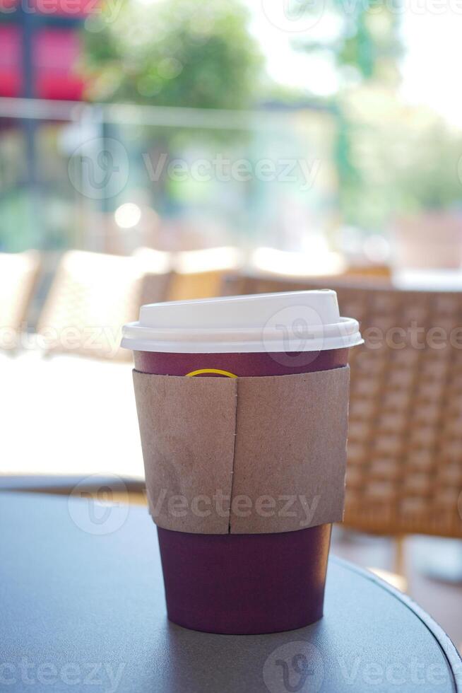 Warm coffee cup resting on a table outdoors in a cozy cafe photo