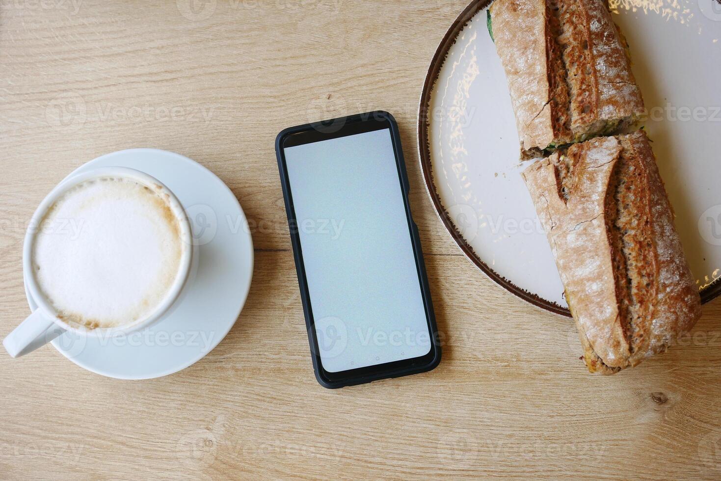 Enjoying coffee and fresh bread at a rustic cafe table photo