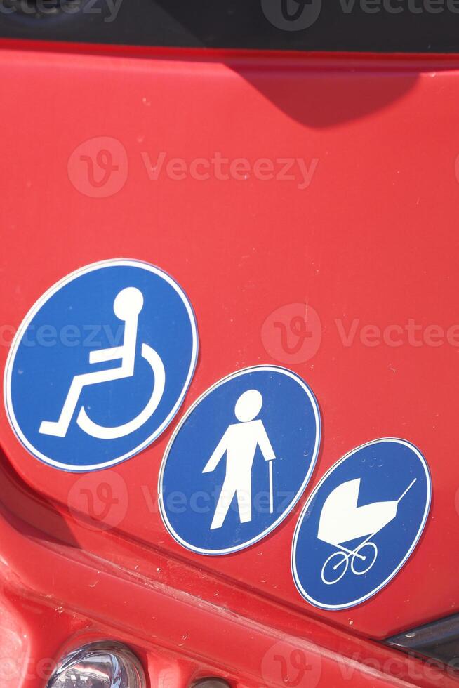 Accessibility symbols displayed on a red surface for public awareness photo