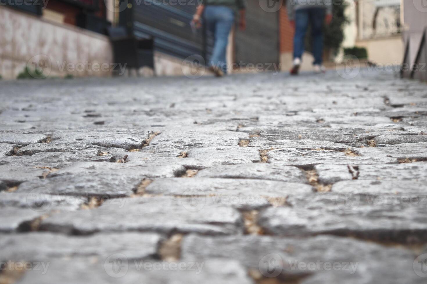 Walking along a cobblestone street in a historic town photo