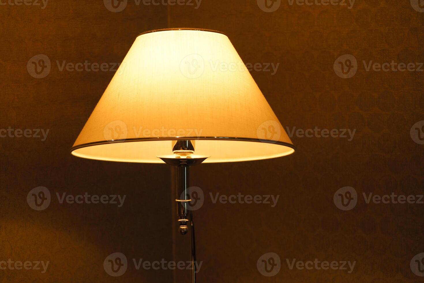 Elegant lamp illuminating a cozy room in warm light photo