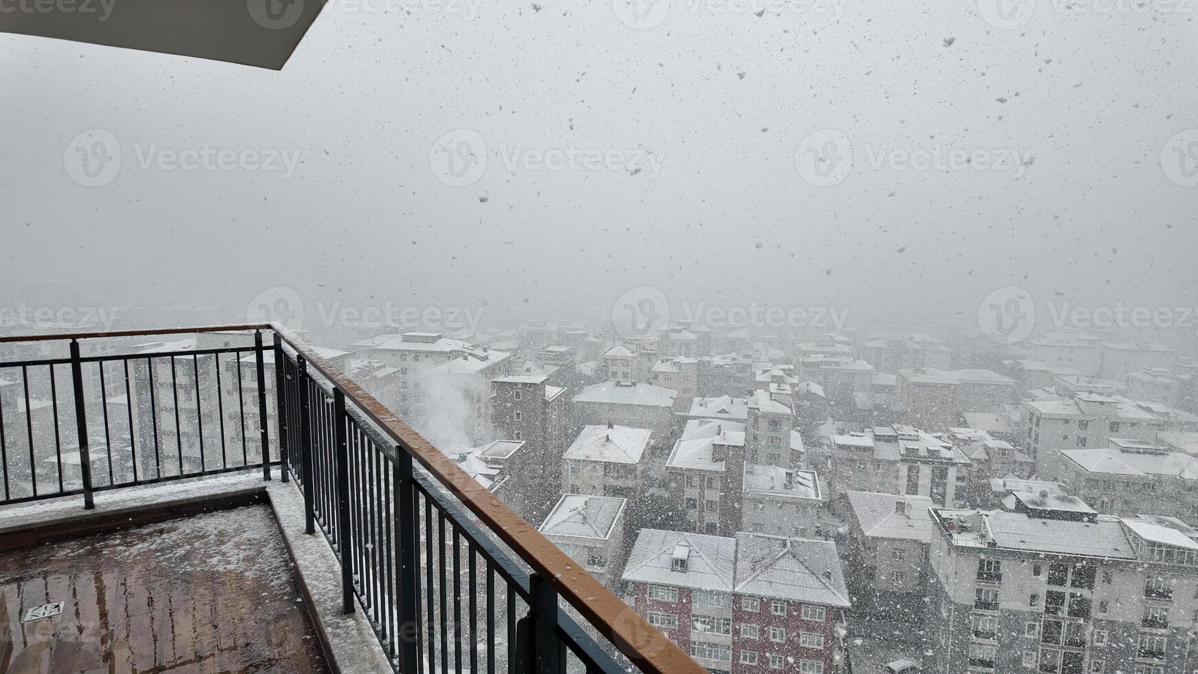 Heavy snowfall blankets city skyline on a winter morning photo