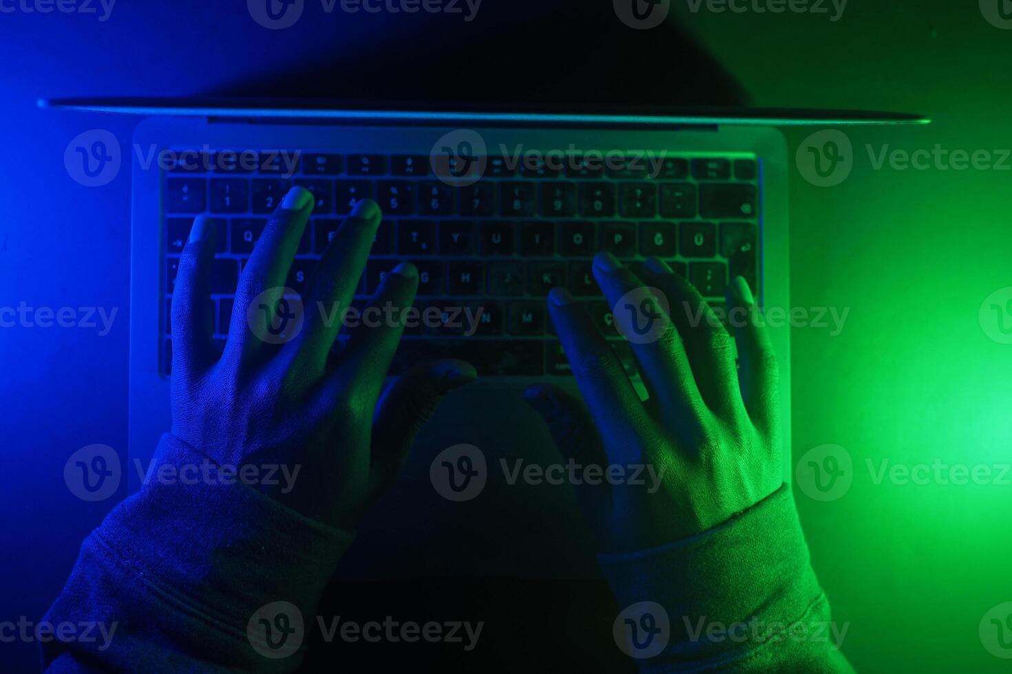 hacker Hands working on a laptop, cyber crime concept photo