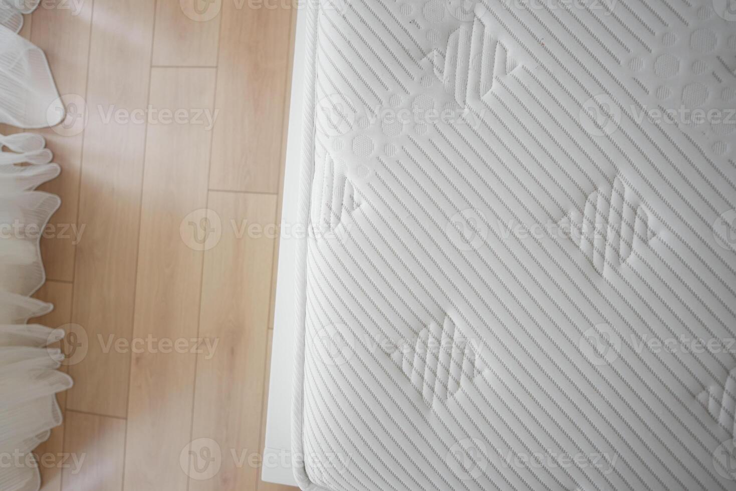 Freshly made bed with a clean white mattress photo