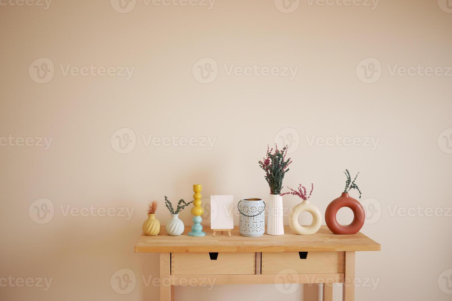Decorative arrangement of vases and plants on a wooden table photo