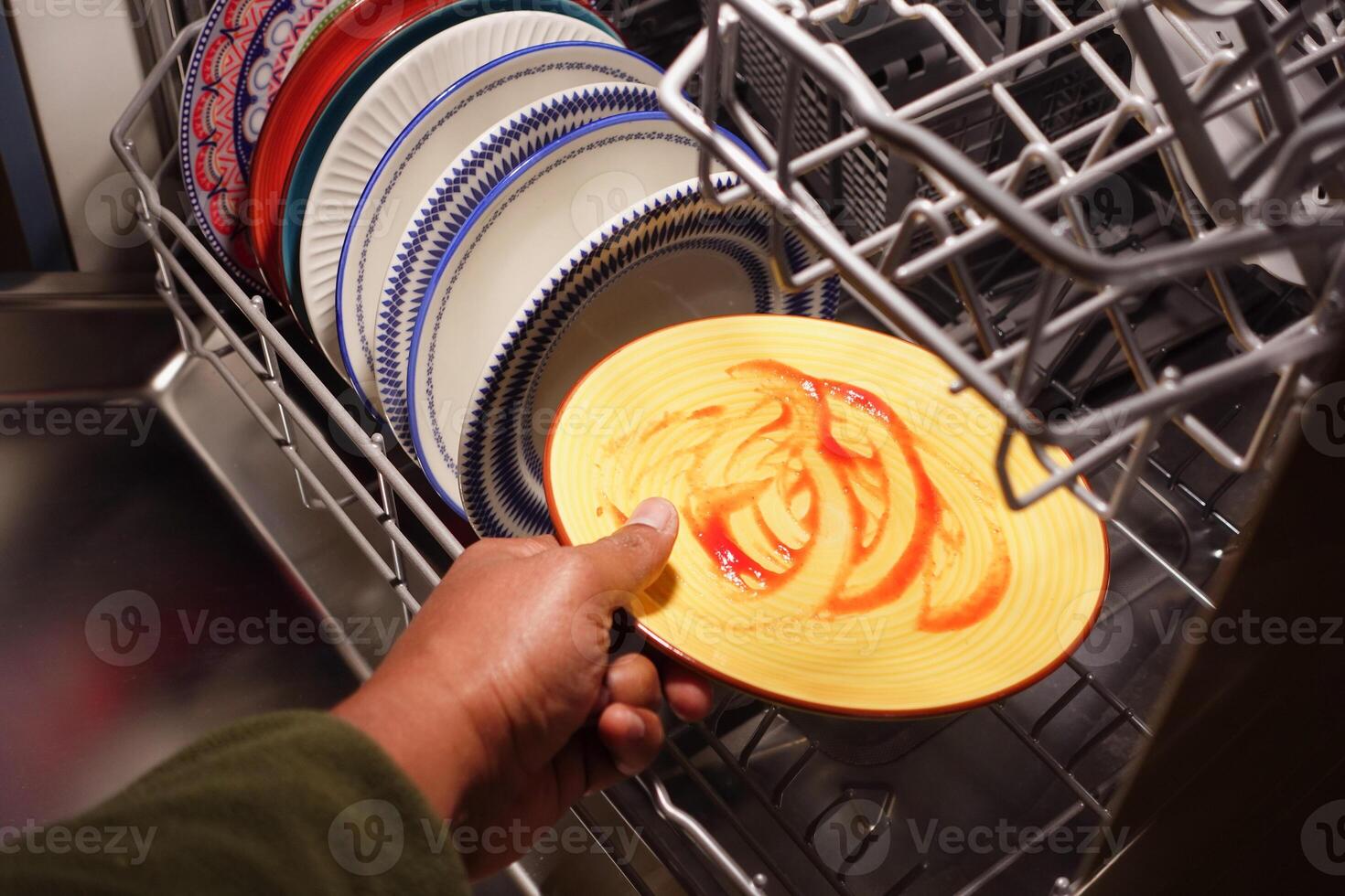 Cleaning a colorful plate inside a modern dishwasher photo