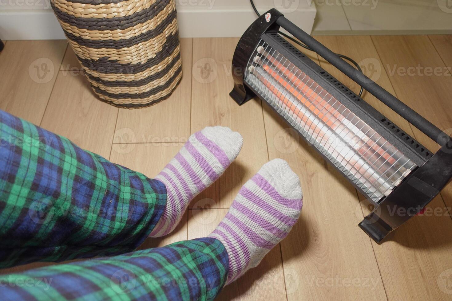 Cozy evening with warm socks next to space heater in living room photo