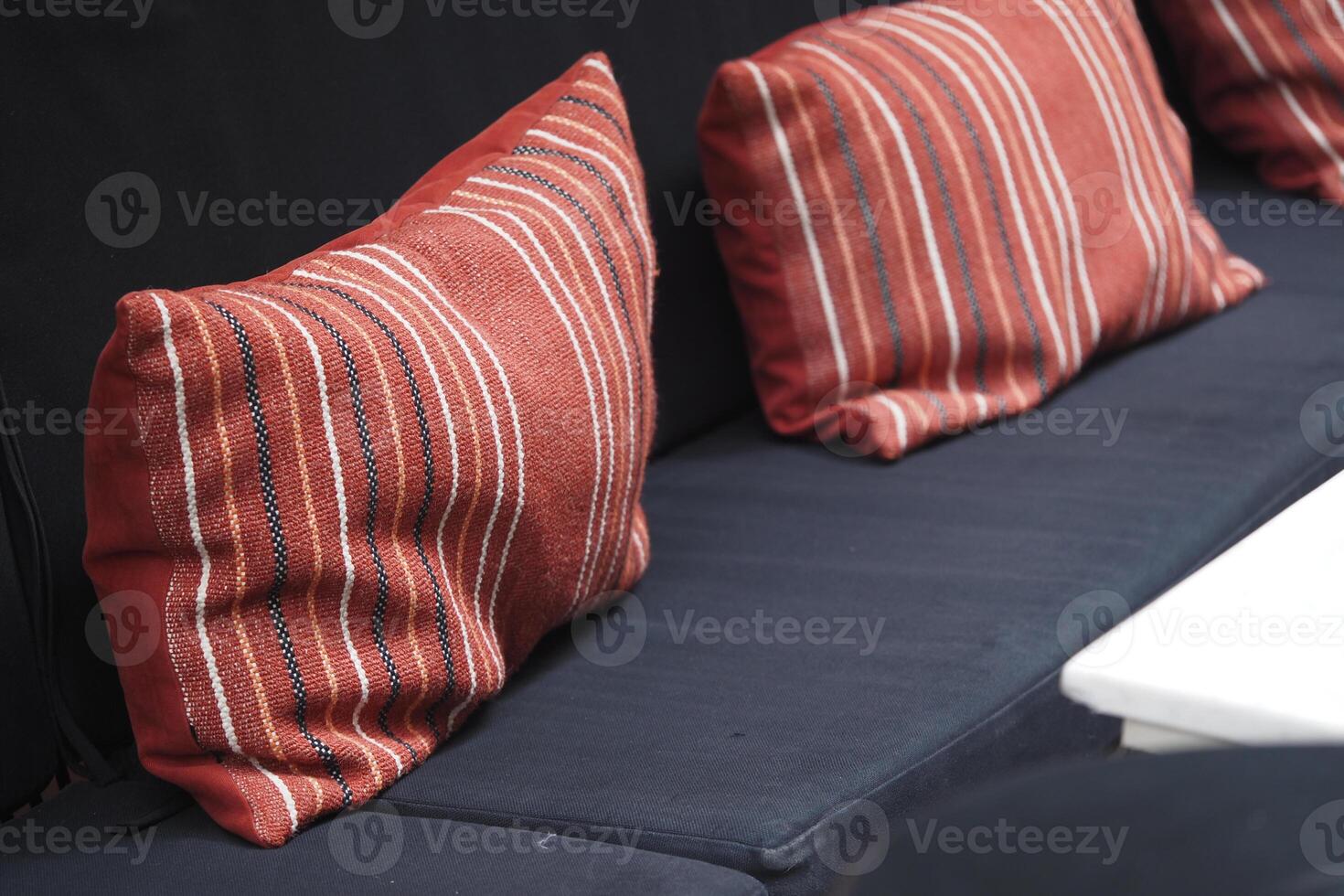 Cozy striped cushions on a dark sofa in a relaxed setting photo