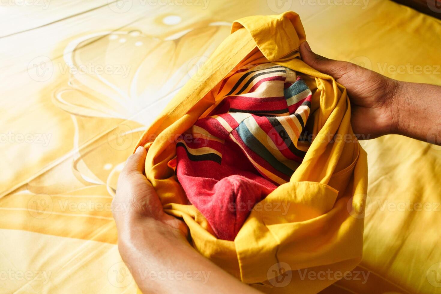 man putting a pillow case in a pillow photo