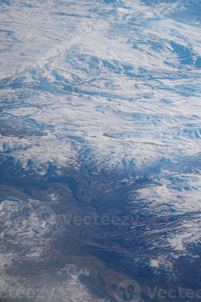 Snowy mountain landscape viewed from high altitude during daytime photo