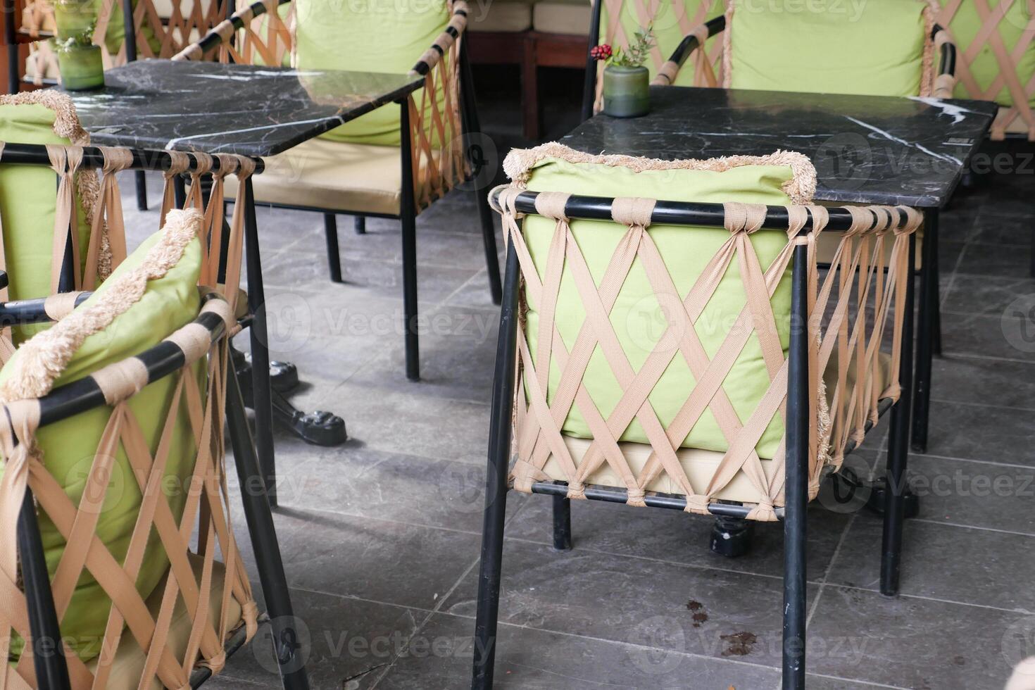 Cozy cafe seating with green cushions in a stylish venue photo