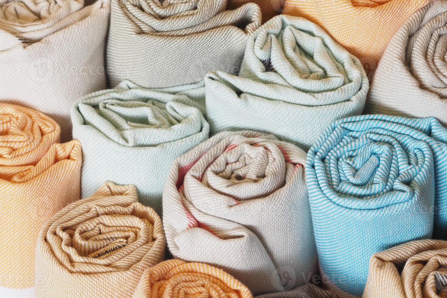 Elegant fabric rolls in soft colors create a charming display photo