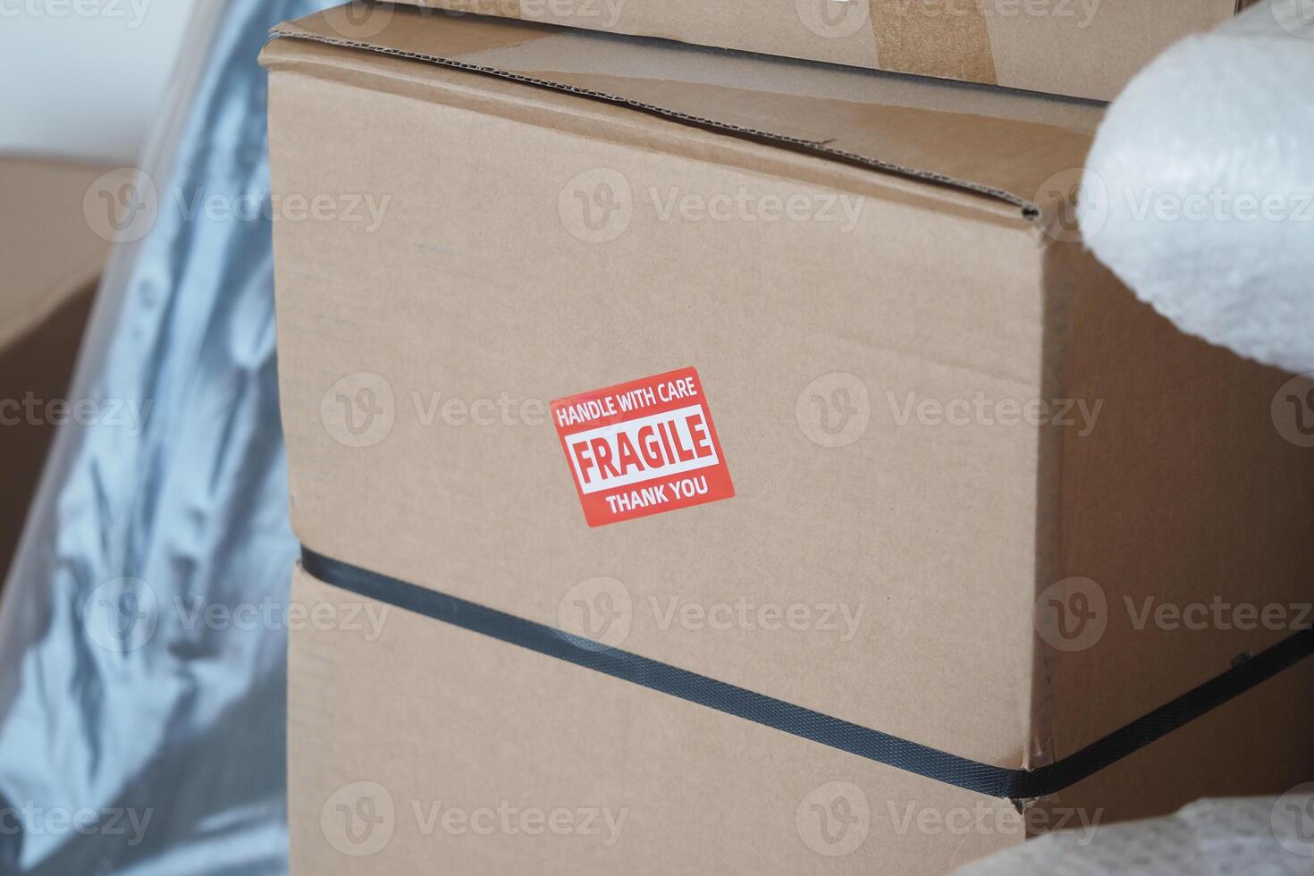 Handling fragile boxes with care during a move in a new home photo