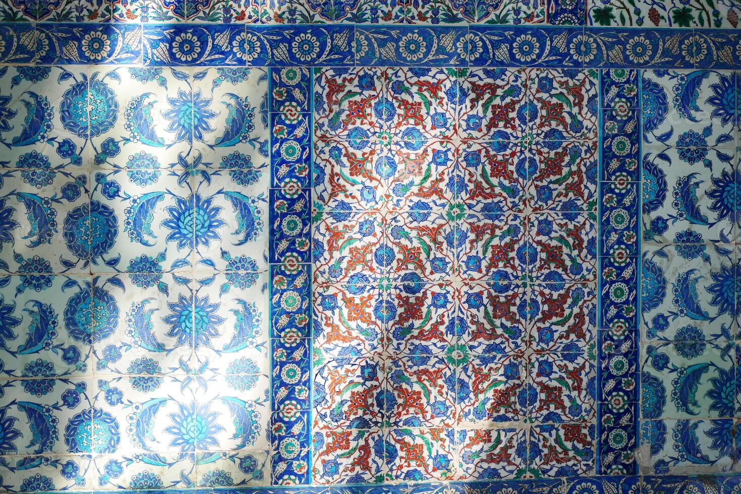 Colorful tile patterns decorate an outdoor wall in a historic location photo