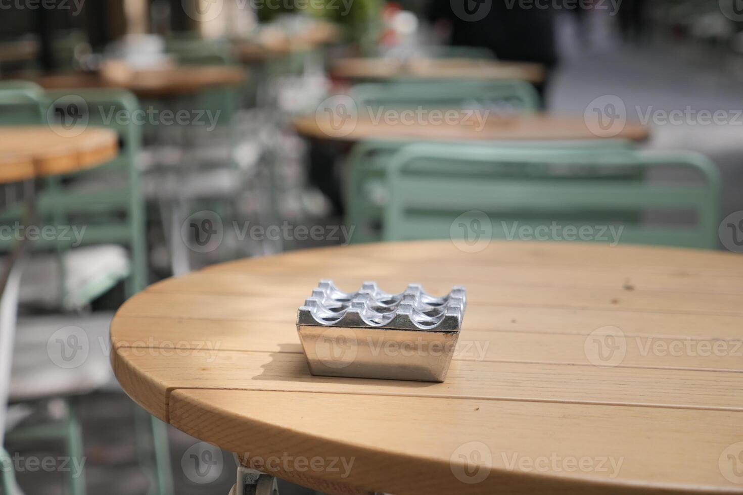 Metal holder with drinks on table at outdoor cafe in spring photo