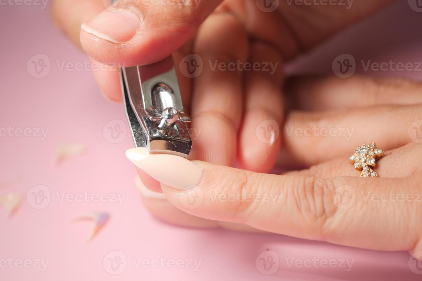 Nail clipping session with elegant manicure in soft lighting photo