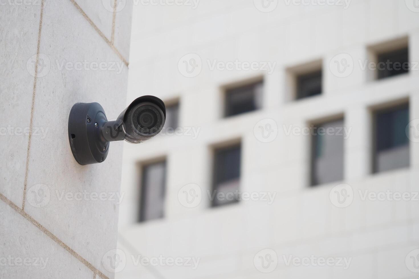 Security camera mounted on a wall at urban location during daylight photo