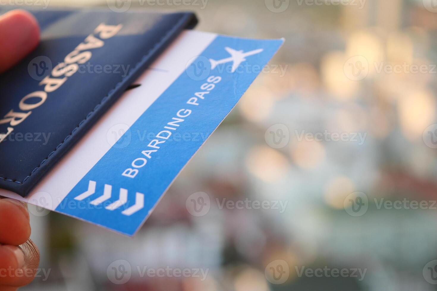 Passport and boarding pass with city backdrop while traveling photo