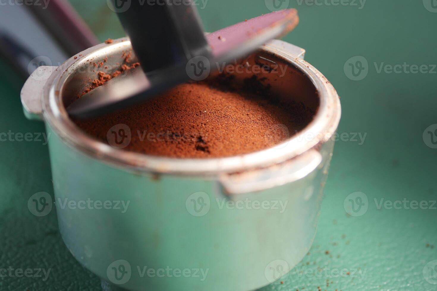 Preparing fresh coffee grounds in a metal coffee filter photo