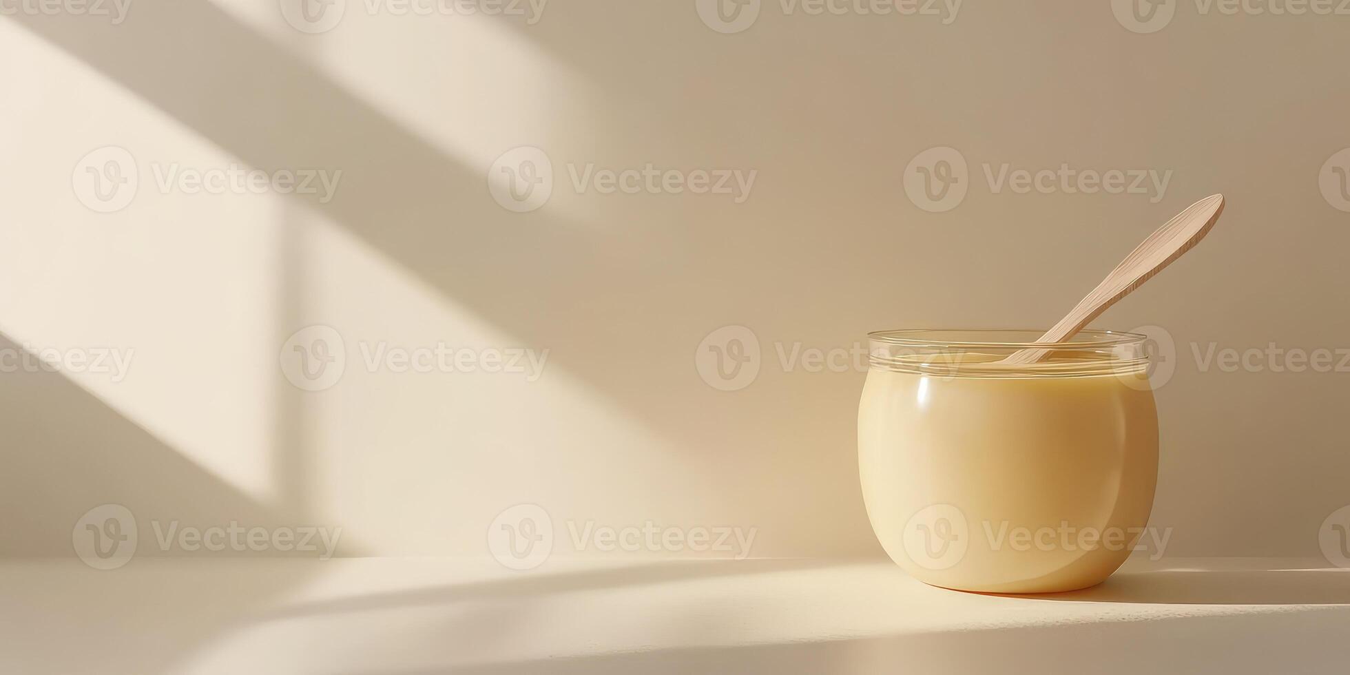 Golden honey in glass jar with wooden spoon on neutral background natural sweetness and culinary ingredient photo