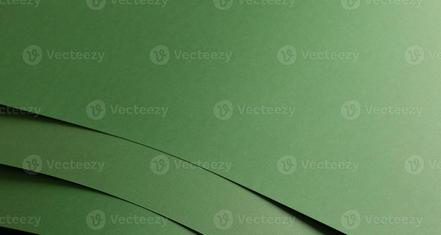 Paper background with matte texture. Layered curved stack in pastel green, grass green, and leafy photo