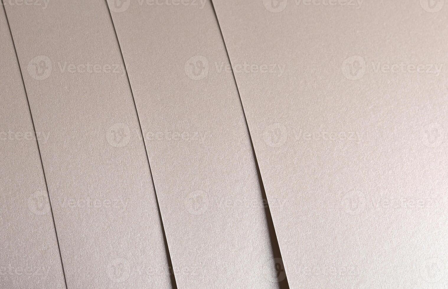 Paper background with satin pearlescent texture. Glossy vertical strips, soft shimmer, pale gold and photo