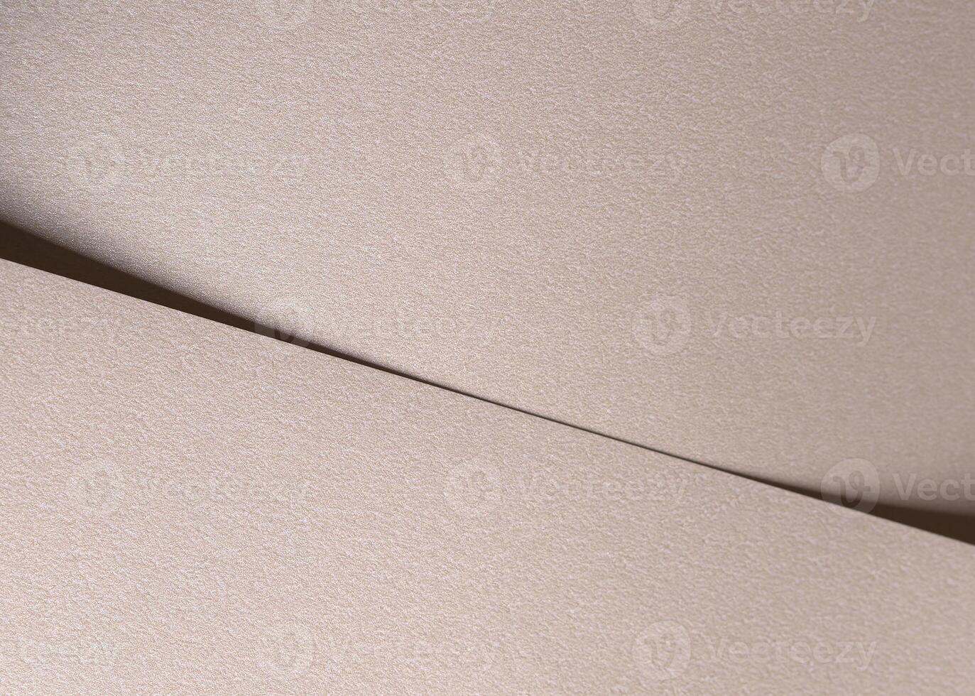Paper background with satin pearlescent texture. Matte folded surface with diagonal overlap, pale photo