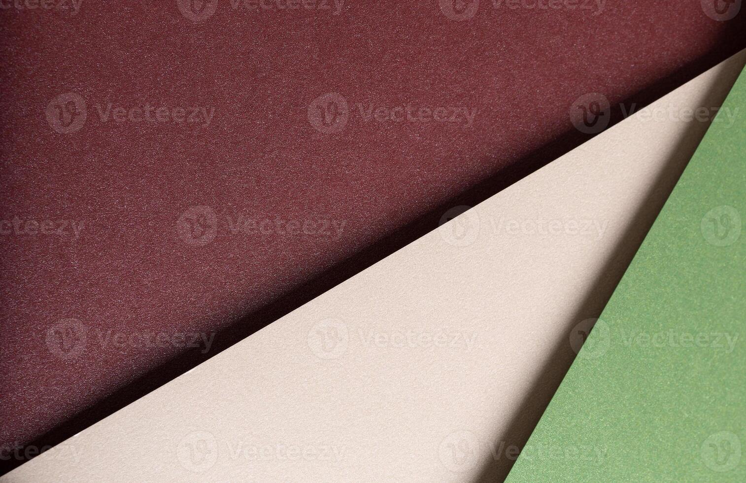 Paper background with matte texture. Layered diagonal sheets in burgundy, maroon, champagne, soft photo