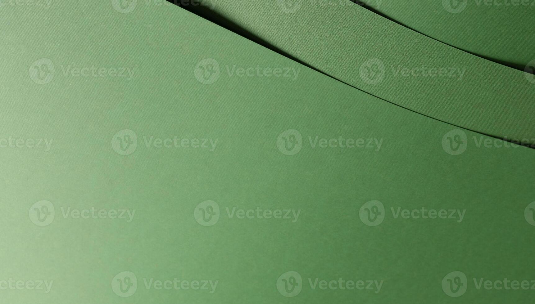 Paper background with matte texture. Curved layered sheets in pastel green, mint green, sage green, photo