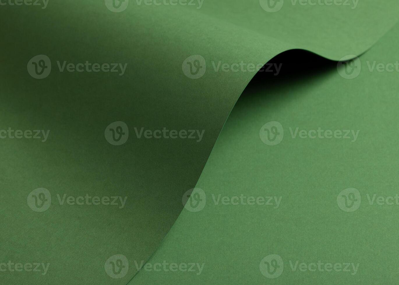 Paper background with matte texture. Curved wave shape in grass green, fresh green, and leafy green photo