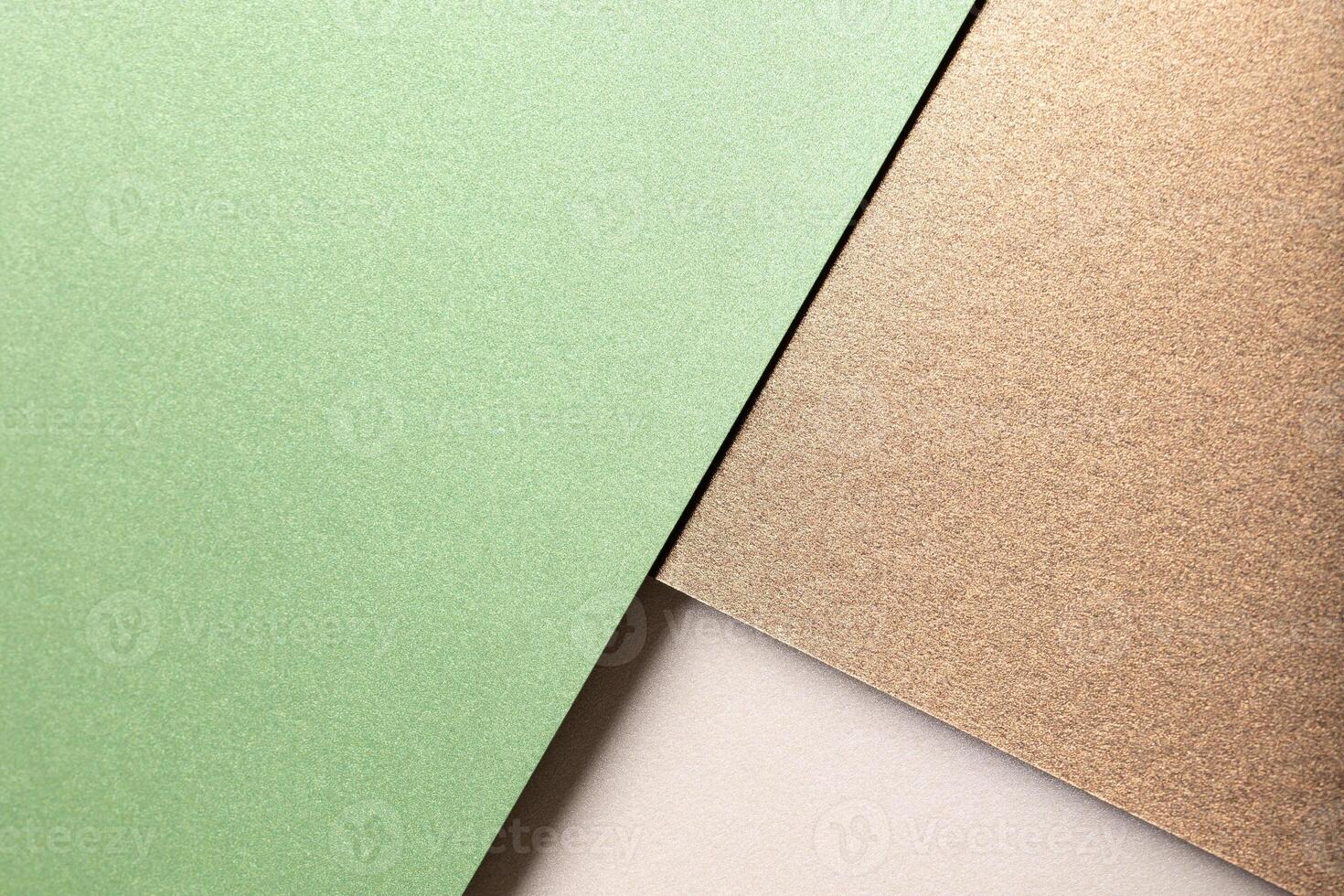 Paper background with matte texture. Layered diagonal sheets in pastel green, mint green, champagne, photo