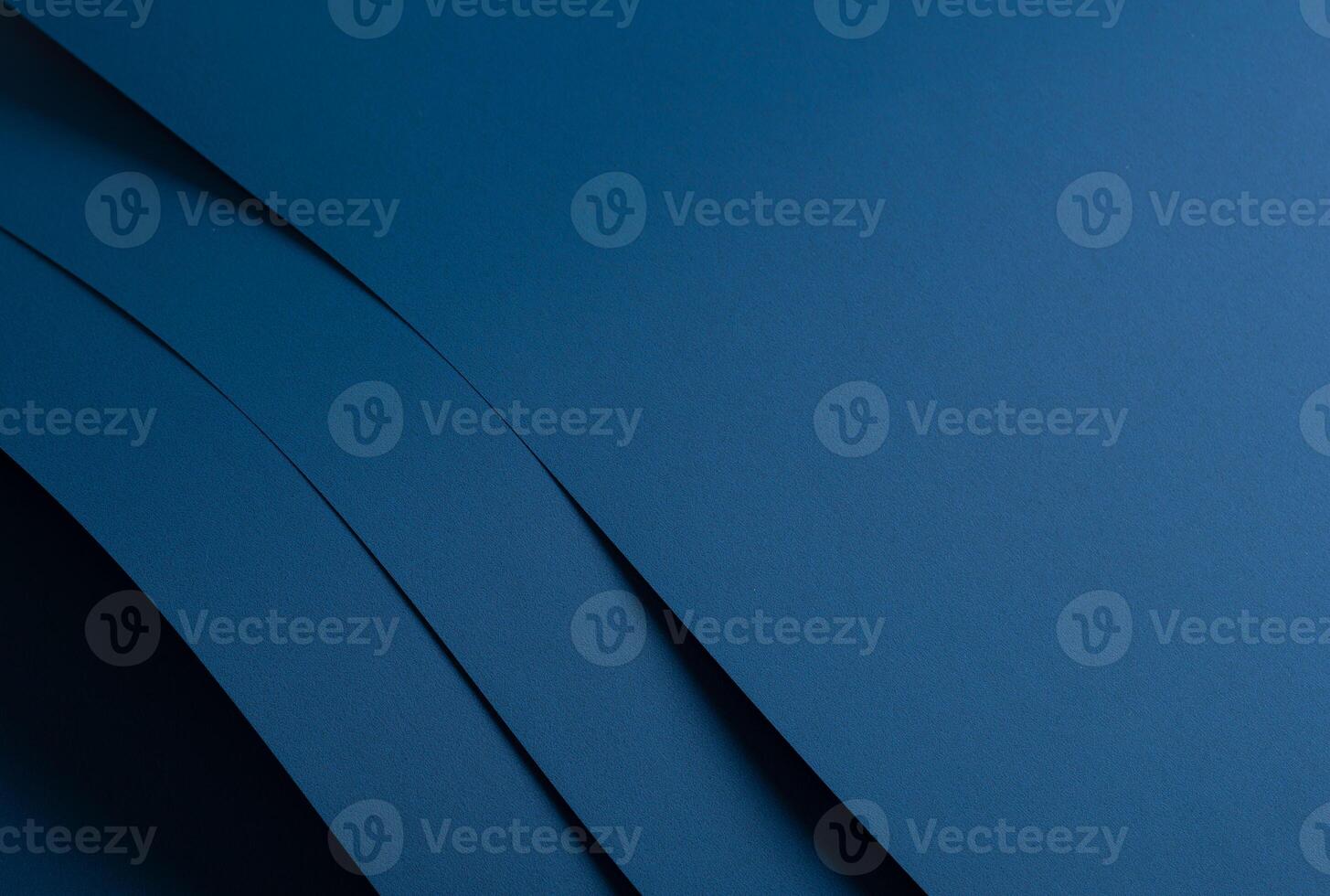 Paper background with matte texture. Layered curved sheets in navy, royal blue, deep blue, and ocean photo