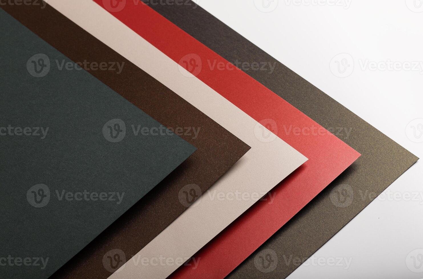 Paper background with matte texture. Layered diagonal sheets in crimson red, soft beige, champagne, photo